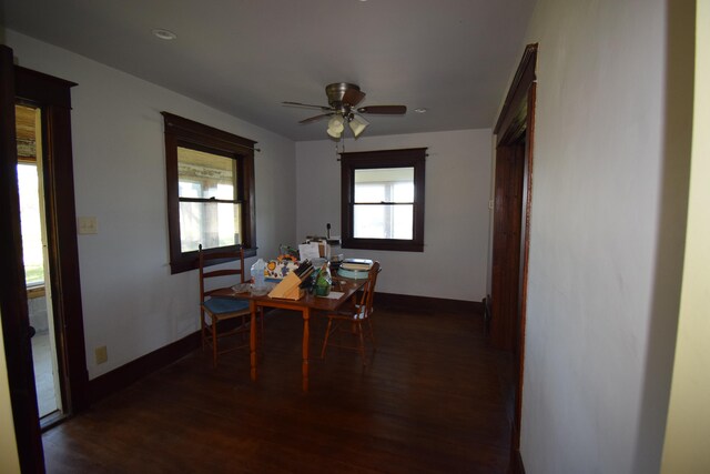 dining area featuring dark wood-type flooring and ceiling fan