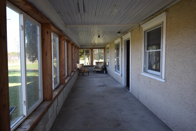 unfurnished sunroom with wooden ceiling