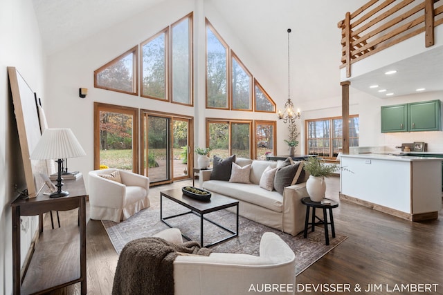 living room with a healthy amount of sunlight, high vaulted ceiling, and dark hardwood / wood-style flooring