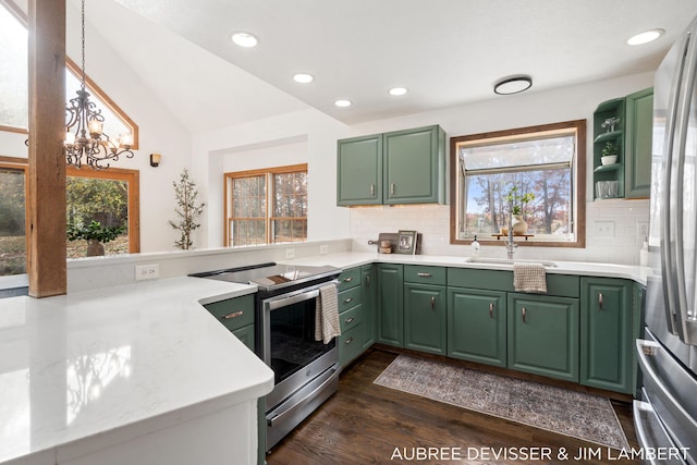 kitchen with appliances with stainless steel finishes, dark hardwood / wood-style floors, and plenty of natural light