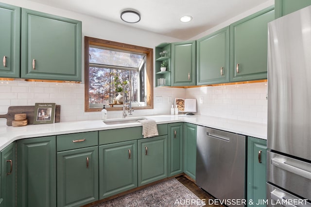 kitchen featuring tasteful backsplash, appliances with stainless steel finishes, and green cabinets