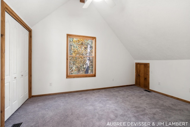 additional living space featuring carpet, vaulted ceiling, and ceiling fan