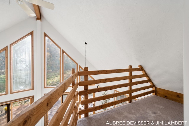 additional living space featuring vaulted ceiling with beams and a textured ceiling