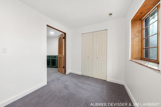 unfurnished bedroom featuring a closet and carpet