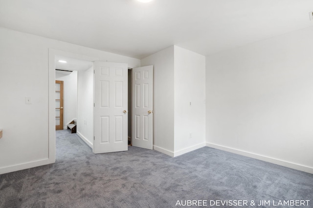 empty room featuring dark colored carpet