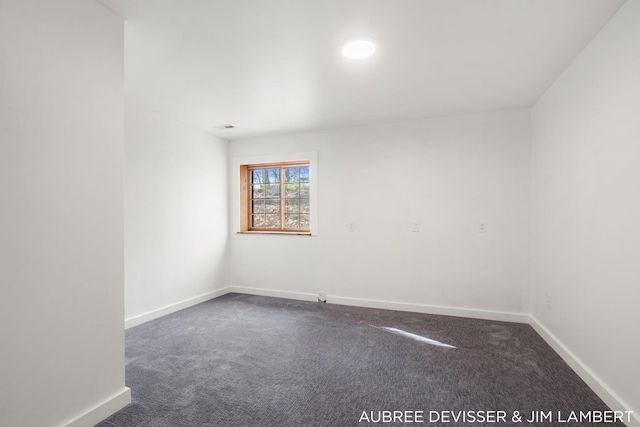 empty room featuring dark colored carpet