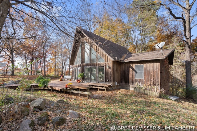 back of house featuring a wooden deck