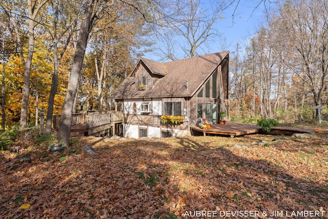 view of side of home featuring a wooden deck