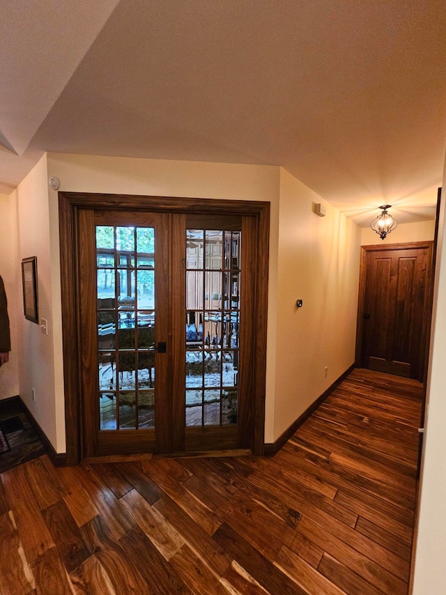 interior space featuring french doors, dark hardwood / wood-style floors, and a textured ceiling