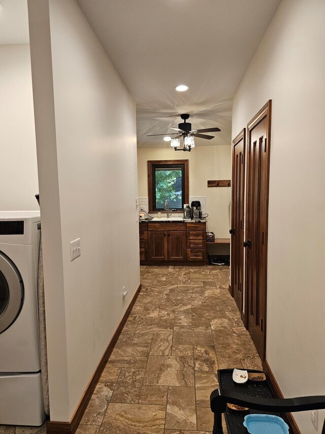 hallway featuring washer / dryer and sink