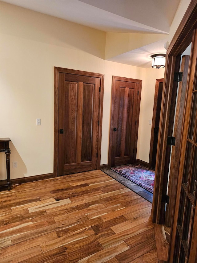 hallway with light hardwood / wood-style flooring