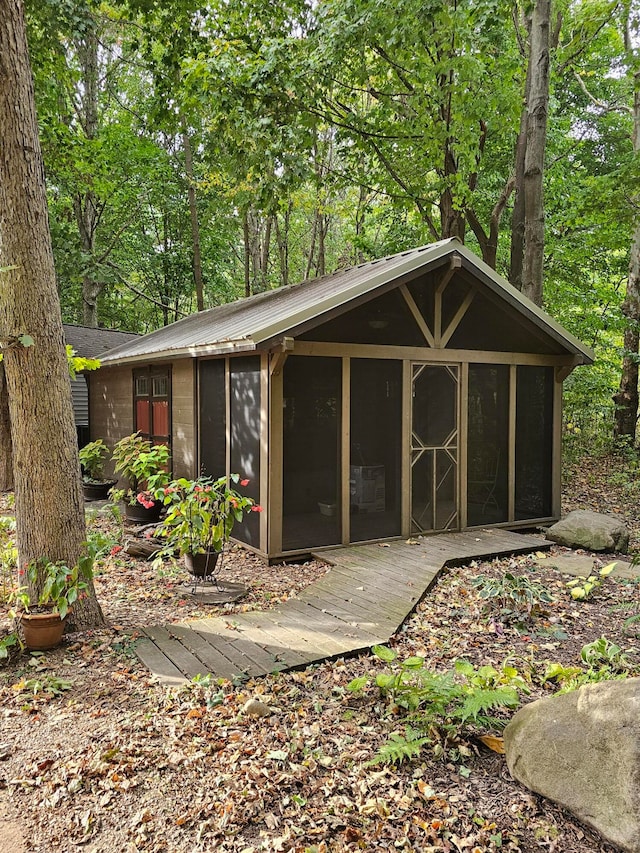 view of outbuilding with a sunroom