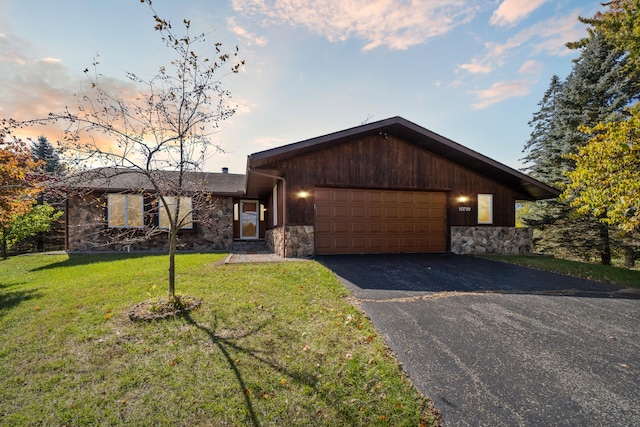 view of front facade with a yard and a garage