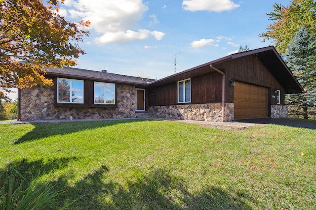 single story home featuring a front yard and a garage