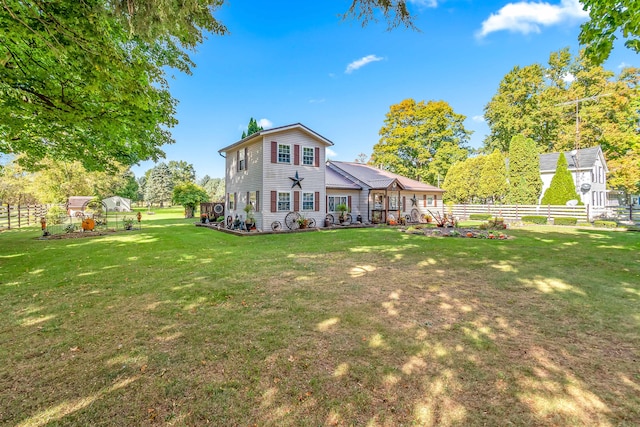 rear view of property featuring a yard