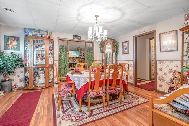 dining room featuring hardwood / wood-style floors and a notable chandelier