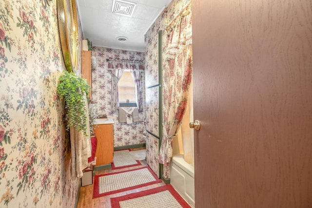 bathroom featuring a tub and vanity