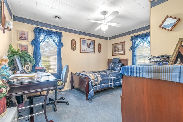 carpeted bedroom with multiple windows and ceiling fan