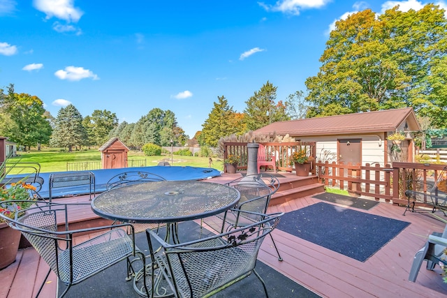 wooden deck featuring a yard and a shed