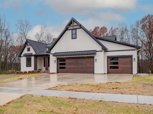 modern inspired farmhouse with a garage