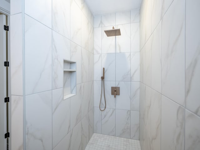 bathroom with a tile shower