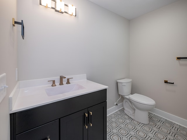 bathroom with tile patterned flooring, vanity, and toilet