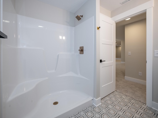 bathroom with tile patterned flooring and walk in shower