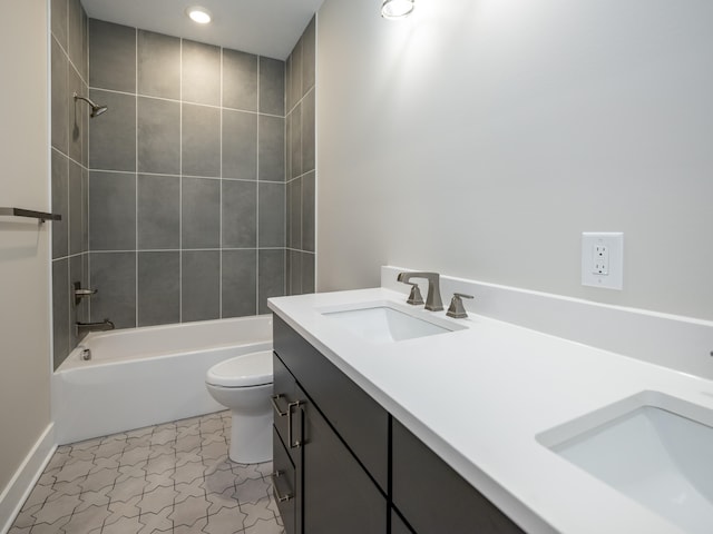 full bathroom featuring toilet, tile patterned flooring, vanity, and tiled shower / bath