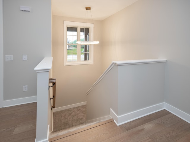 stairway featuring hardwood / wood-style flooring