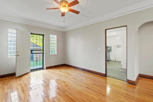 empty room featuring crown molding, ceiling fan, and light hardwood / wood-style flooring