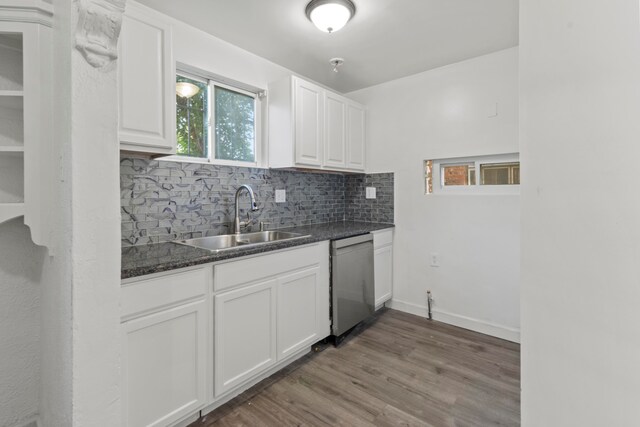 kitchen featuring hardwood / wood-style floors, sink, white cabinetry, and stainless steel dishwasher