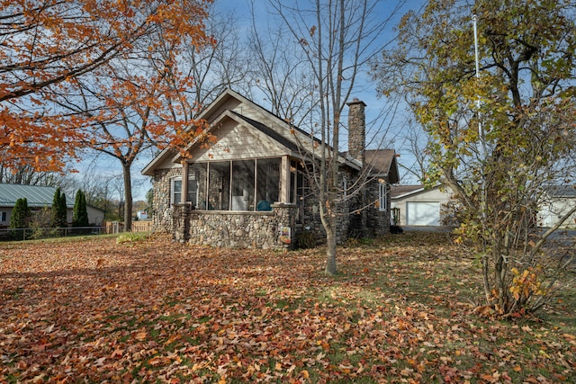 view of front of property with a garage and a sunroom