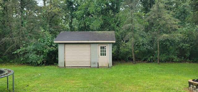 view of outbuilding featuring a trampoline and a yard