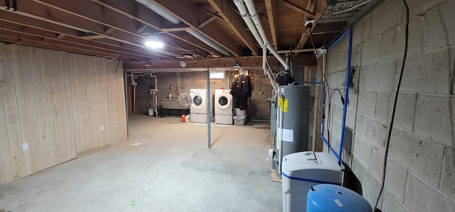 basement with independent washer and dryer, sink, and water heater