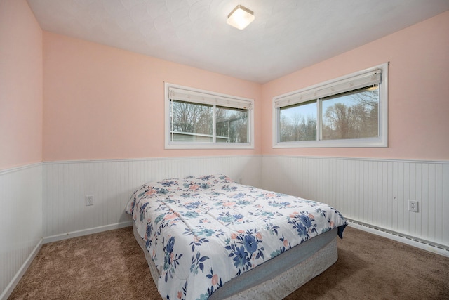 carpeted bedroom with a baseboard radiator