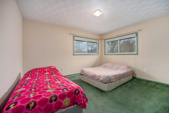 bedroom with carpet floors and baseboard heating