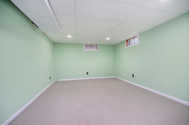 basement featuring a drop ceiling and carpet floors