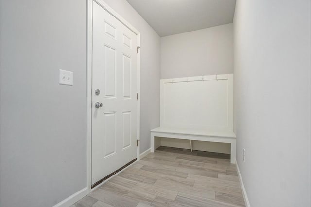 mudroom with light hardwood / wood-style floors