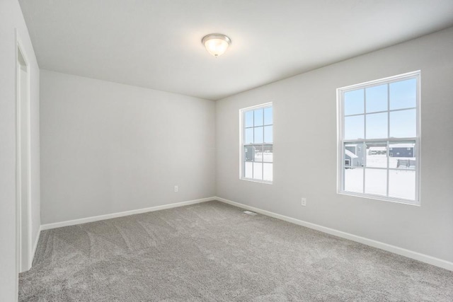 unfurnished room featuring carpet