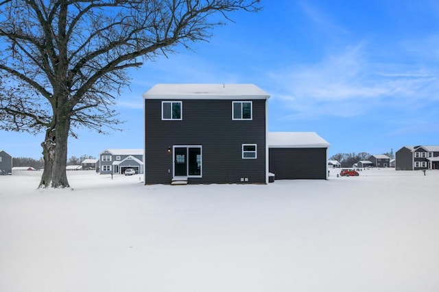 view of snow covered back of property