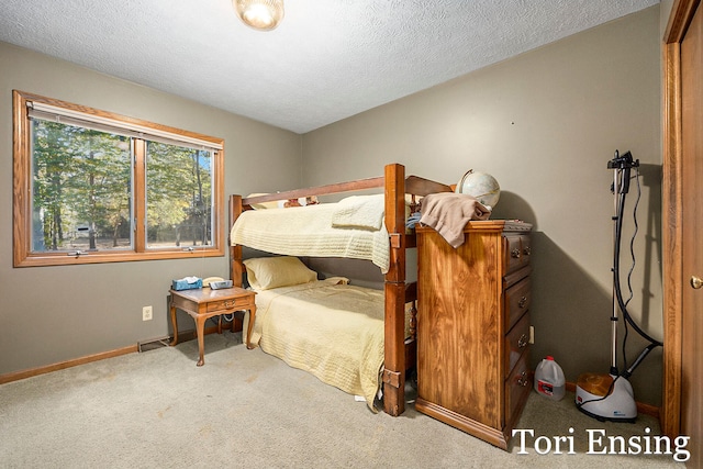 bedroom with carpet flooring and a textured ceiling