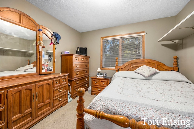 carpeted bedroom with a textured ceiling