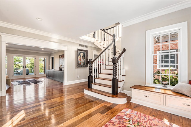 foyer with french doors, hardwood / wood-style flooring, and ornamental molding