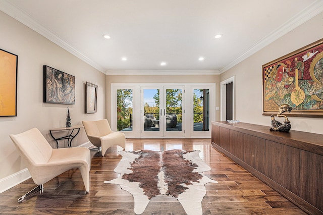 living area featuring hardwood / wood-style floors, ornamental molding, and french doors