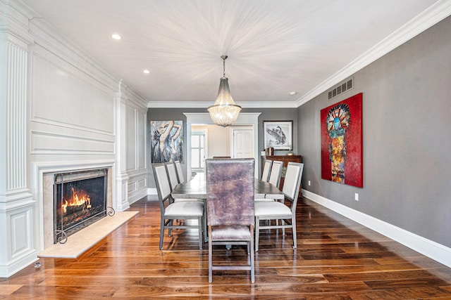 dining room featuring a chandelier, dark wood-type flooring, and ornamental molding