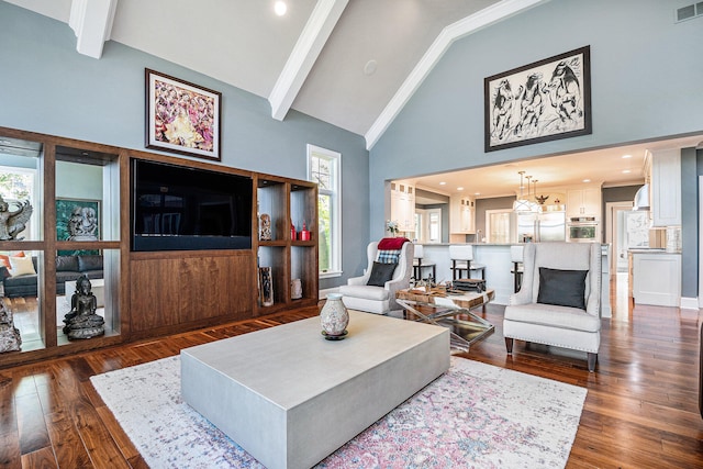 living room with a chandelier, beamed ceiling, high vaulted ceiling, and dark wood-type flooring