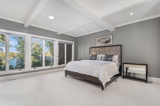 bedroom featuring beamed ceiling, carpet flooring, and multiple windows