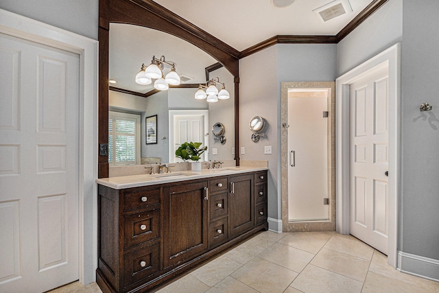 bathroom with tile patterned floors, crown molding, vanity, and a notable chandelier