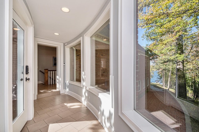 unfurnished sunroom featuring plenty of natural light