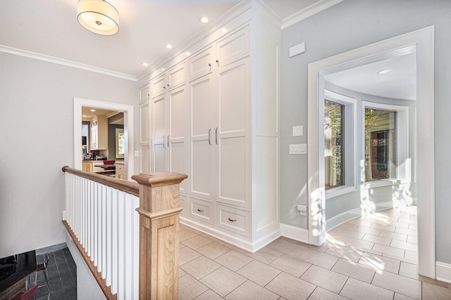 corridor featuring crown molding, light tile patterned flooring, and a healthy amount of sunlight